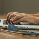 Compliance officer reviewing 42 CFR Part 2 SUD record-handling procedures on a laptop next to clinical documentation at a behavioral health program
