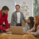 a group of people sitting around a wooden table