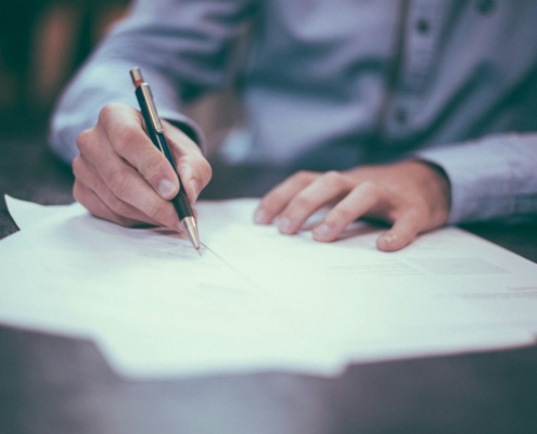 Regulatory compliance documents on desk during behavioral health facility licensing review