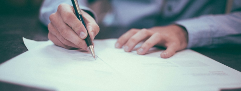 Regulatory compliance documents on desk during behavioral health facility licensing review