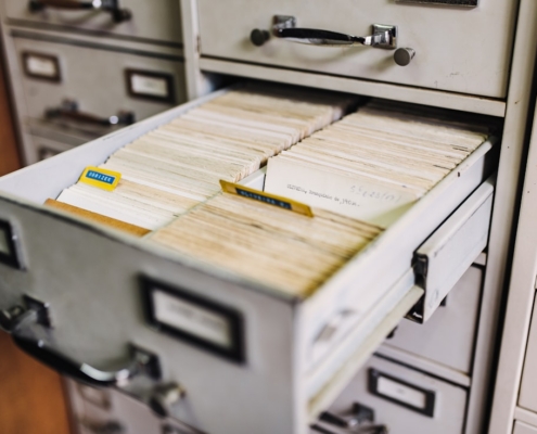 Open file cabinet drawer of patient records illustrating 42 CFR Part 2 confidentiality rules for substance use disorder records