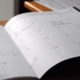 Open monthly planner used to map an annual behavioral health compliance calendar
