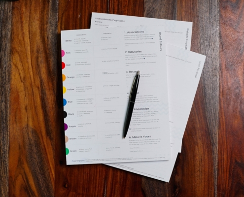 Tabbed credentialing documents and pen organized for provider profile data review