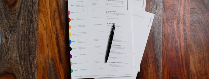 Tabbed credentialing documents and pen organized for provider profile data review