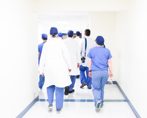 Clinical team walking a facility corridor during a Joint Commission standards survey