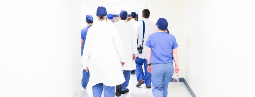 Clinical team walking a facility corridor during a Joint Commission standards survey